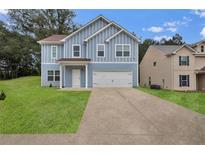 Charming blue two-story home with a well-manicured lawn and a two car garage at 4401 Belcamp Rd, Union City, GA 30213