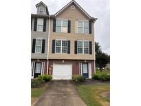 Charming townhome with a one-car garage and tidy front yard at 6231 Redan Overlook, Lithonia, GA 30058