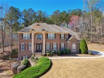 Charming two-story brick home featuring manicured landscaping and a welcoming front entrance at 5615 Toccoa Dr, Douglasville, GA 30135