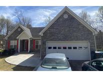 Charming stone front home with attached two car garage and long driveway at 2517 Oak Valley Ln, Dacula, GA 30019