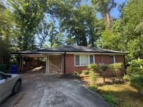 Charming brick ranch-style home with mature trees and a convenient carport at 2875 Monterey Dr, Decatur, GA 30032