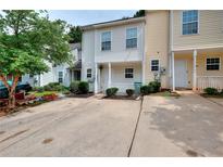 Inviting townhouse features a quaint front porch and well-maintained landscaping at 6344 Wellington Walk Way, Lithonia, GA 30058