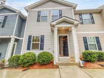 Inviting two-story townhome with gray siding, black shutters, and landscaped front yard at 2138 Chadwick Sw Rd, Atlanta, GA 30331