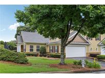 Charming two-story home with attached garage, well-maintained landscaping, and mature trees at 2721 Grapevine Cir # 1701, Cumming, GA 30041