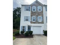 Two-story townhouse with blue shutters, a garage, and partial stone facade at 4336 Thorngate Ln, Acworth, GA 30101
