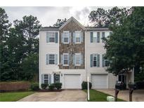 Charming townhome featuring stone accents, blue shutters, and a one-car garage at 4336 Thorngate Ln, Acworth, GA 30101