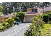 Charming townhome with a well-maintained front yard, attached garage, and driveway at 1523 Dillard Rd, Stone Mountain, GA 30088