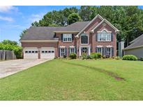 Charming two-story brick home featuring a well-manicured lawn and a spacious two-car garage at 3765 Peachbluff Ct, Duluth, GA 30097