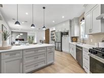 Bright eat-in kitchen with stainless steel appliances, island, and hardwood flooring at 42 Riverdale St, Canton, GA 30114