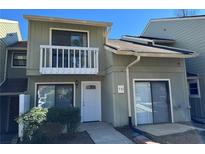 Charming two-story home featuring a balcony, modern siding, and well-maintained landscaping at 731 Hanover Se Ln, Marietta, GA 30067