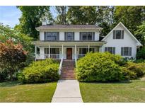 Charming two-story home with a covered front porch and lush landscaping at 1974 Skyland Glen Dr, Snellville, GA 30078