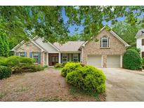 Charming brick home with a two-car garage, manicured landscaping, and inviting curb appeal at 3633 Gilpin Ct, Lawrenceville, GA 30044