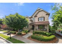 Charming two-story home with a beautifully landscaped front yard and inviting front porch at 1741 Hickory Path Way, Suwanee, GA 30024