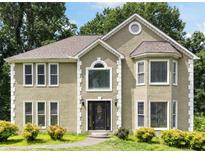 Charming two-story home with an arched window above the front door and detailed trim at 2108 Yorkshire Ct, Woodstock, GA 30189