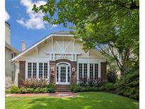 Charming brick home with a well-manicured lawn, arched entryway, and large windows at 16 Walker Ne Ter, Atlanta, GA 30309