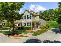Charming two-story home with a well-manicured front yard and a driveway at 397 Cypher Dr, Suwanee, GA 30024