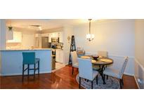 This dining area features a round wooden table, seating for four, and wood flooring at 1315 Mcgill Park Ne Ave, Atlanta, GA 30312