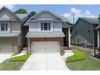 Charming brick and siding townhome with a two-car garage and well-maintained lawn at 2968 Oshields Sw Ct # 4, Marietta, GA 30060