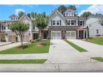 Charming townhomes feature stone accents, attached garages, and manicured front lawns at 146 Bellehaven Dr, Woodstock, GA 30188