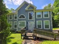 Inviting two-story home with a sloped front yard, decorative windows, and a convenient ramp to the front door at 6797 Lombard Ct, Lithonia, GA 30058