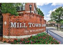 Mill Town Lofts entrance featuring a brick sign and well-maintained landscaping at 791 Wylie Se St # 404, Atlanta, GA 30316
