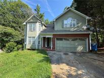 Two story home boasts traditional architecture, attached garage, and mature trees at 2615 Windage Sw Dr, Marietta, GA 30008
