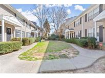 Attractive condo community with mature landscaping, sidewalks and brick buildings at 2232 Dunseath Nw Ave # 309, Atlanta, GA 30318