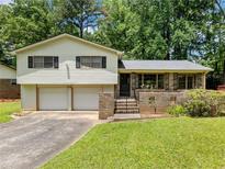 Charming home with a two-car garage and well-maintained lawn and brickwork at 784 San Miguel Dr, Stone Mountain, GA 30083