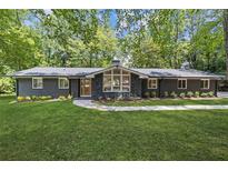 Charming single-story home with painted brick, new roof, and professionally landscaped front yard at 3008 Ridgeside Ct, Atlanta, GA 30341