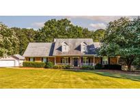 Charming brick home with well-manicured lawn and inviting front porch at 184 Wildflower Dr, Social Circle, GA 30025