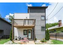 Modern two-story home featuring mixed siding, a wooden balcony, and professionally landscaped yard at 76 Mayson Avenue Northeast Ne, Atlanta, GA 30307
