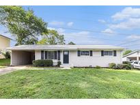 Charming one-story home featuring a brick facade, carport, and well-maintained front yard at 3787 Stephanie Sw Dr, Atlanta, GA 30331