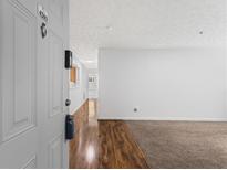 Inviting entryway with hardwood floors leads into a bright, carpeted living space at 4203 Fairington Village Dr, Lithonia, GA 30038