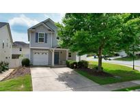 Charming two-story home with a well-manicured lawn, attached garage, and inviting entryway at 400 Silver Spring St, Dallas, GA 30157