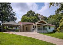 Charming single-story home with a welcoming front porch, carport, and a well-manicured lawn at 4523 Doc Sams Rd, Cumming, GA 30028