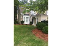 Charming home boasts a well-manicured lawn and neatly trimmed bushes, creating a welcoming curb appeal at 1697 Preserve Park Dr, Loganville, GA 30052
