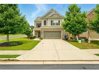 Charming two-story home with a well-manicured lawn and attached two car garage at 119 Hardy Water Dr, Lawrenceville, GA 30045
