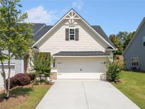 Charming home with a well-manicured lawn and a two-car garage and a lovely front yard with attractive plantings at 4571 Grenadine Cir, Acworth, GA 30101