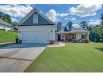 Charming home with a two-car garage, a lawn, and a cozy front porch perfect for relaxing at 5105 Ashley Falls Ct, Loganville, GA 30052
