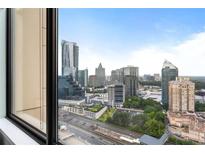 Stunning city view through a large window showcases nearby architecture and an expansive sky at 3445 Stratford Rd # 3102, Atlanta, GA 30326