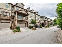 Charming townhome complex featuring neutral exteriors, private garages, and inviting front porches and decks at 680 Emeril Dr, Avondale Estates, GA 30002