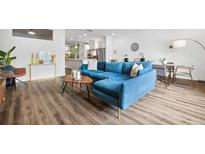 Bright living room featuring a blue sofa, modern decor, and a dining area in an open layout at 24 Becker Nw Pl, Atlanta, GA 30307