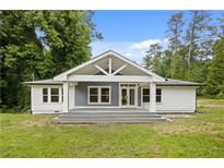 Charming home featuring a welcoming front porch, gray accents, and a well-manicured lawn at 2552 Scenic S Hwy, Snellville, GA 30078