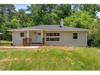 Charming one-story home with a brick facade, manicured lawn, and inviting front porch at 1364 Willis Mill Sw Rd, Atlanta, GA 30311