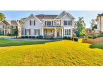 Beautiful two-story home featuring a manicured lawn and a well-maintained landscape at 2837 Captain Ct, Dacula, GA 30019