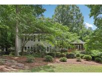 Charming home with mature trees, stone path, and well-maintained landscaping enhances its curb appeal at 159 Cavan Se Way, Mableton, GA 30126