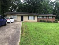Charming single-story home with a well-maintained lawn and mature trees at 4485 Merlin Ne Cir, Douglasville, GA 30134