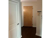 Home entrance features a wooden front door and light walls at 361 17Th Nw St # 1303, Atlanta, GA 30363