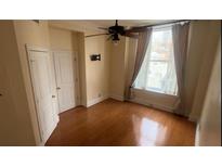 Neutral bedroom featuring hardwood floors, natural light, and a ceiling fan at 57 Forsyth Nw St # 11B, Atlanta, GA 30303