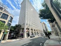 A striking exterior view of a tall building, complemented by a vibrant urban scene with blue skies at 57 Forsyth Nw St # 11B, Atlanta, GA 30303